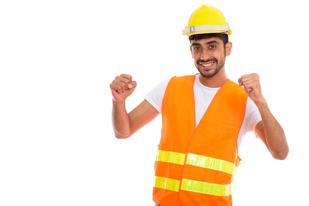 Young happy Persian man construction worker smiling while lookin