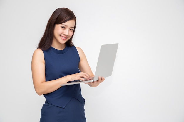 Young happy smiling Asian woman holding laptop