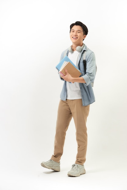 Young happy student carrying books