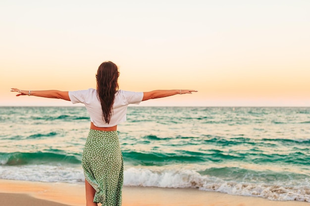 Young happy woman on the beach enjoy her summer vacation Girl is happy and calm in her stay on the beach