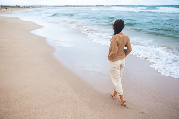 Young happy woman on the beach