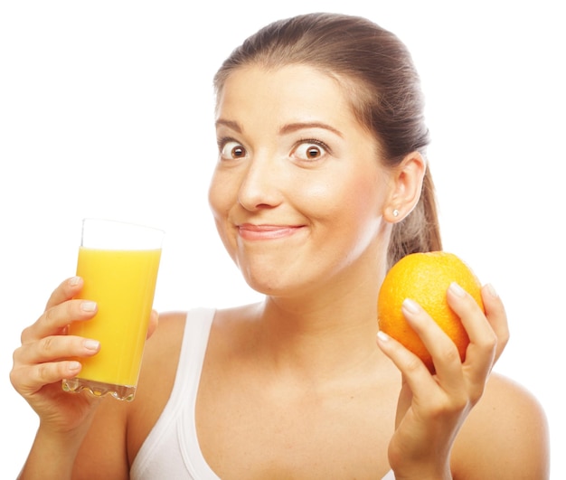 Young happy woman drinking orange juice