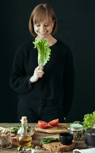 Young happy woman in the kitchen