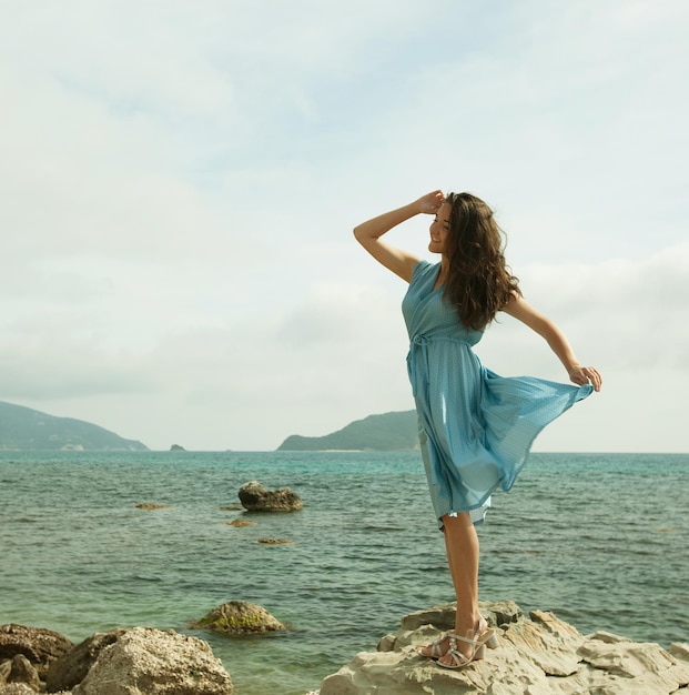 Young happy woman posing near sea summer vacation