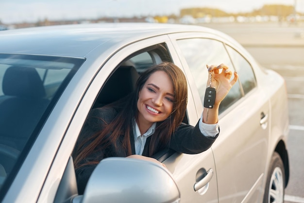 Young Happy Woman Showing The Key Of New Car