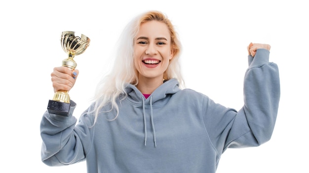 A young happy woman with a cup of the winner of the competition on a white background