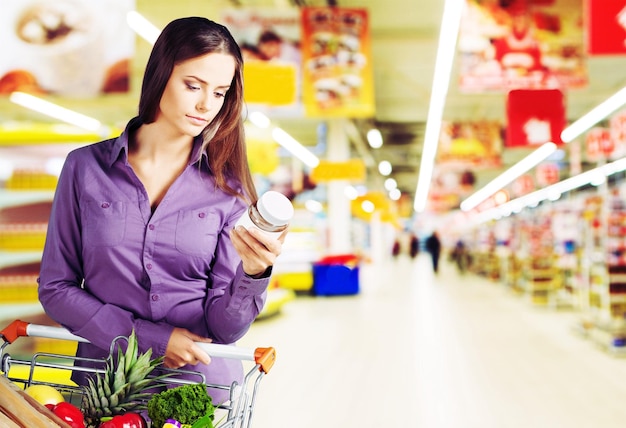 Young happy woman with shopping cart