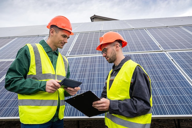 Young hardy men in overalls arrived to discuss a plan to install solar panels