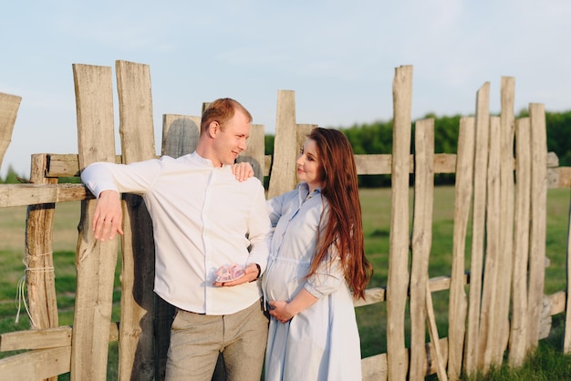 Young heterosexual pregnant couple in an outdoor park