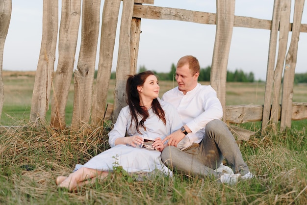 Young heterosexual pregnant couple in an outdoor park