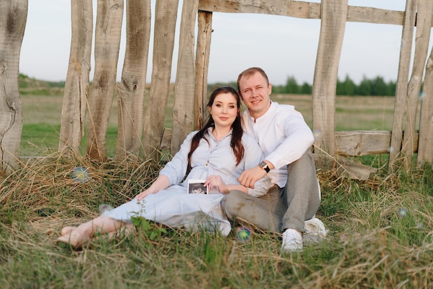 Young heterosexual pregnant couple in an outdoor park