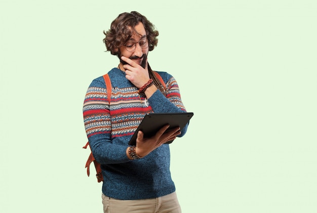 Young hippie man with a tablet