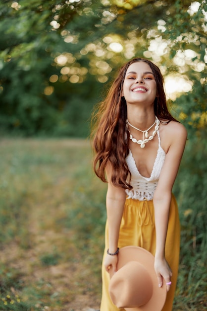 A young hippie woman dancing merrily and smiling earnestly in nature in the fall The concept of economical consumption and selfcare High quality photo