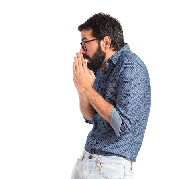 Young hipster man pleading over white background