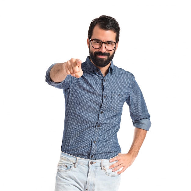 Young hipster man pointing to the front