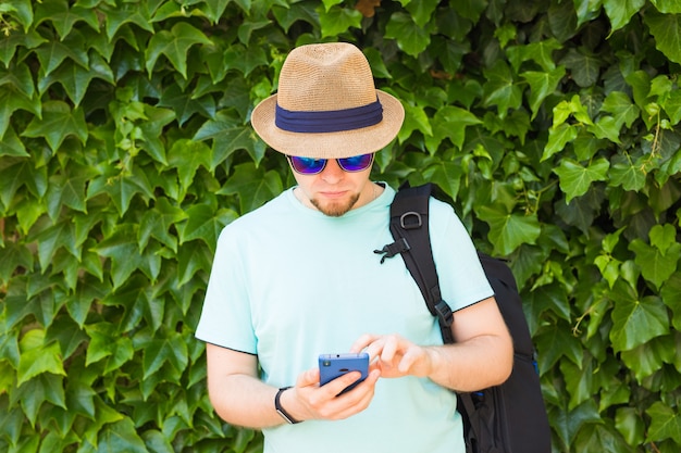 Young hipster man using mobile smart phone.