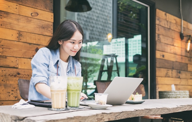 Young hipster woman enjoy online social community on laptop 