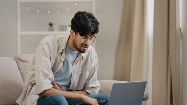 Young hispanic arab indian business man freelancer worker male bearded student wearing glasses