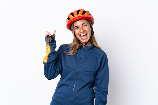 Young hispanic cyclist woman isolated on white smiling and showing victory sign