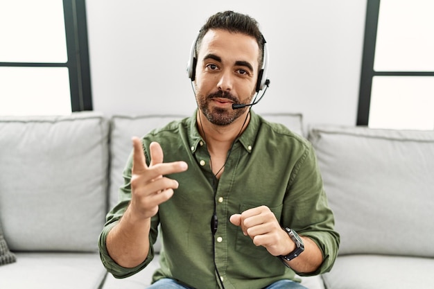 Young hispanic man call center agent working at home