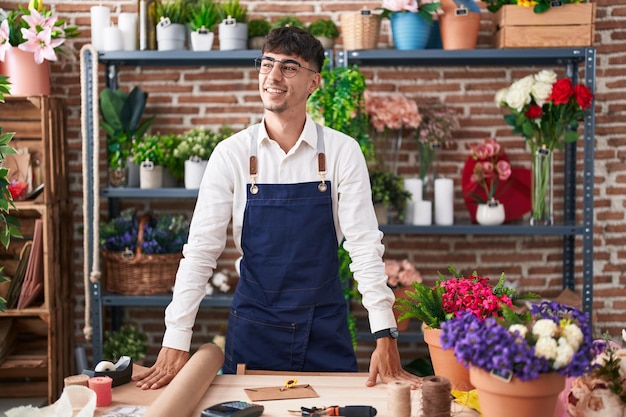 Young hispanic man florist smiling confident standing at florist