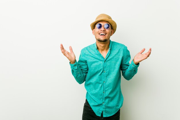 Young hispanic man wearing a summer clothes joyful laughing a lot. Happiness concept.