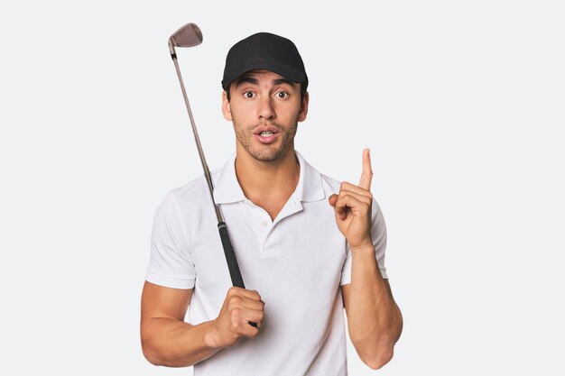 Young Hispanic man with golf club having some great idea concept of creativity