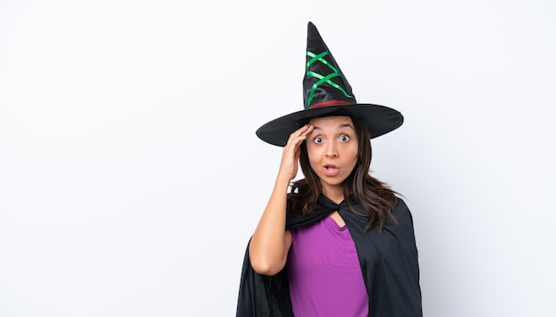 Young hispanic woman dressed as witch over isolated background has realized something and intending the solution