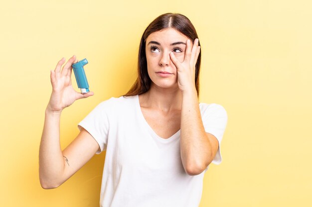 Young hispanic woman feeling bored, frustrated and sleepy after a tiresome. asthma concept