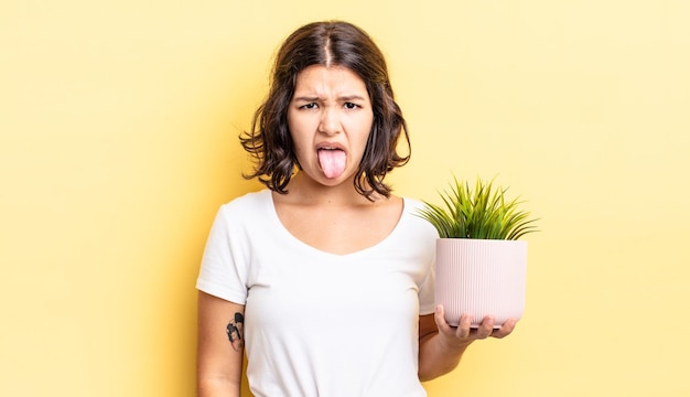 Photo young hispanic woman feeling disgusted and irritated and tongue out. growth concept