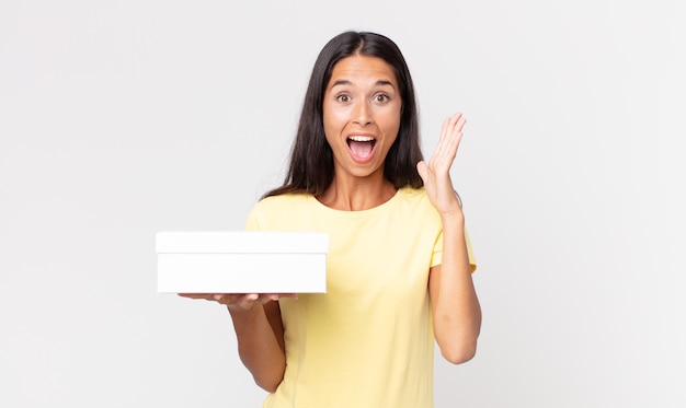 Young hispanic woman feeling happy and astonished at something unbelievable