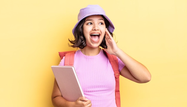 Young hispanic woman feeling happy, excited and surprised. back to school concept