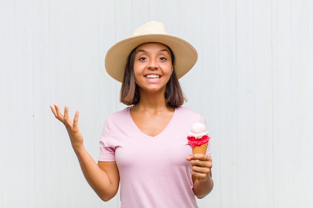 Young hispanic woman feeling happy, surprised and cheerful, smiling with positive attitude, realizing a solution or idea