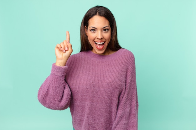 Young hispanic woman feeling like a happy and excited genius after realizing an idea