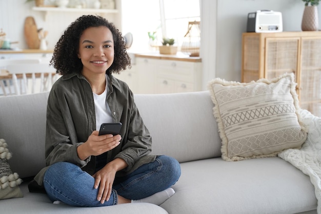 Young hispanic woman is browsing social media Online book reading Lazy weekend morning