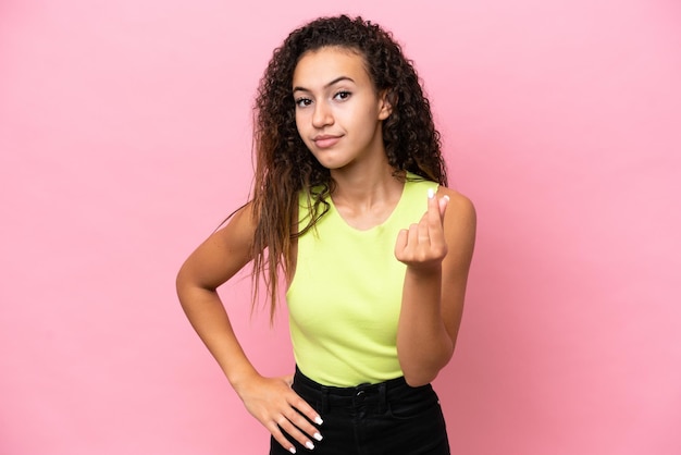 Young hispanic woman isolated on pink background making Italian gesture