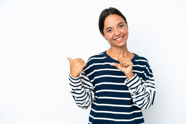 Young hispanic woman isolated on white background pointing to the side to present a product