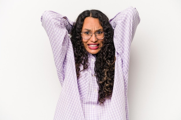 Young hispanic woman isolated on white background screaming with rage