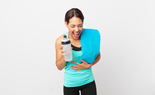 Young hispanic woman laughing out loud at some hilarious joke. fitness concept