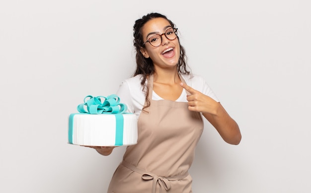 Young hispanic woman looking excited and surprised pointing to the side and upwards to copy space