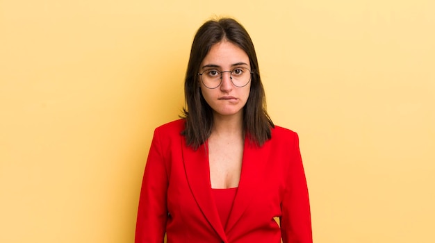 Young hispanic woman looking puzzled and confused business concept