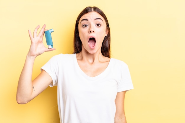 young hispanic woman looking very shocked or surprised. asthma concept