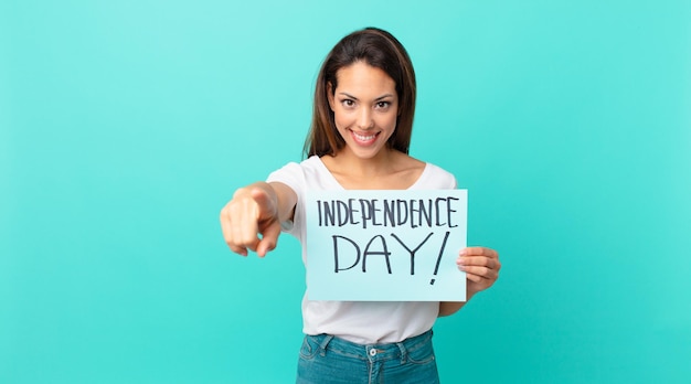 Young hispanic woman pointing at camera choosing you. independence day concept