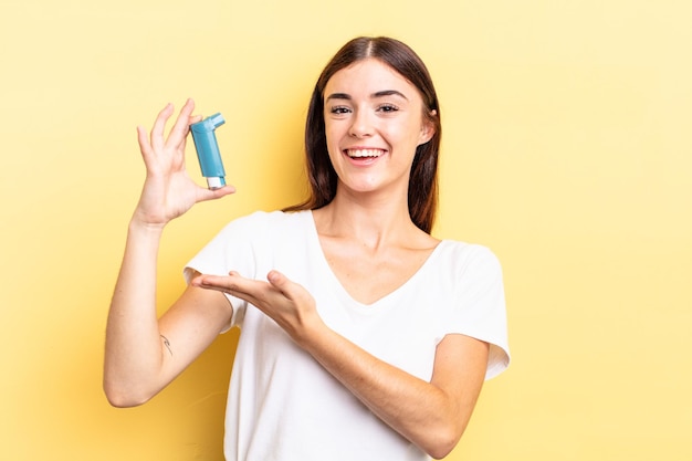 Young hispanic woman smiling cheerfully, feeling happy and showing a concept. asthma concept