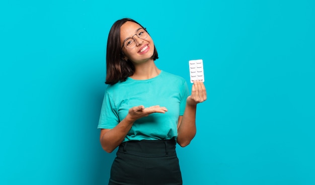 Young hispanic woman smiling cheerfully, feeling happy and showing a concept