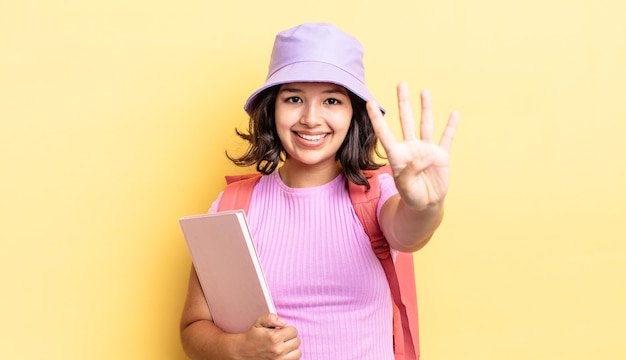 Young hispanic woman smiling and looking friendly, showing number four. back to school concept