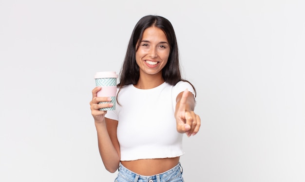 Young hispanic woman smiling proudly and confidently making number one and holding a take away coffee container