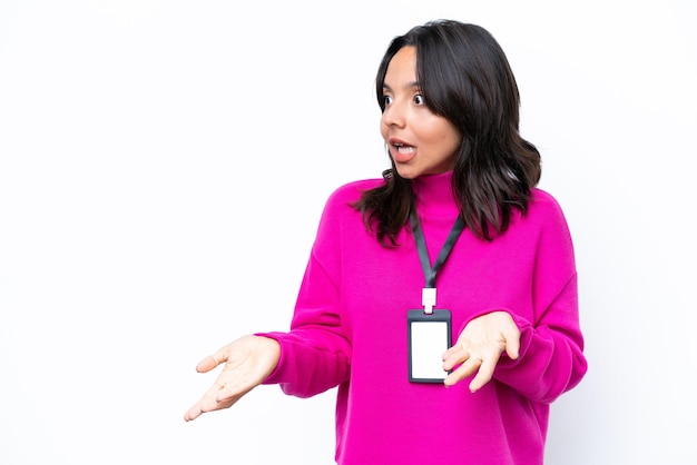 Young hispanic woman with ID card isolated on white background with surprise facial expression