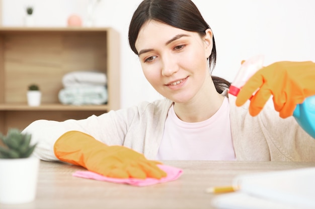 Young housewife is doing house cleaning closeup