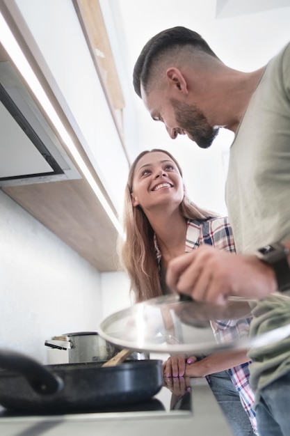 Young husband and wife cook dinner together